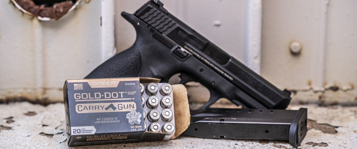 Gold Dot Carry Gun box sitting in front of a handgun