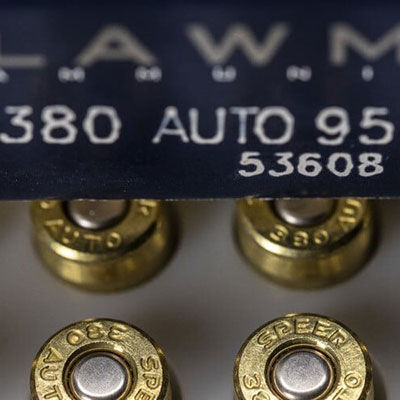 shooter loading a magazine into a handgun