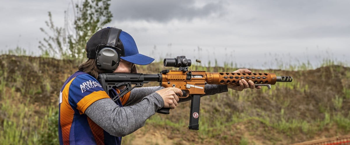 shooter aiming rifle outside