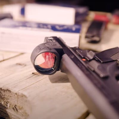 handgun with a red dot laying on a table