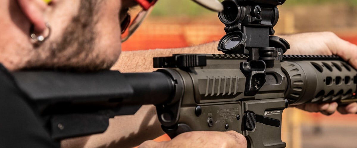 shooter looking down the scope of a rifle