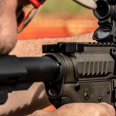 shooter looking down the scope of a rifle