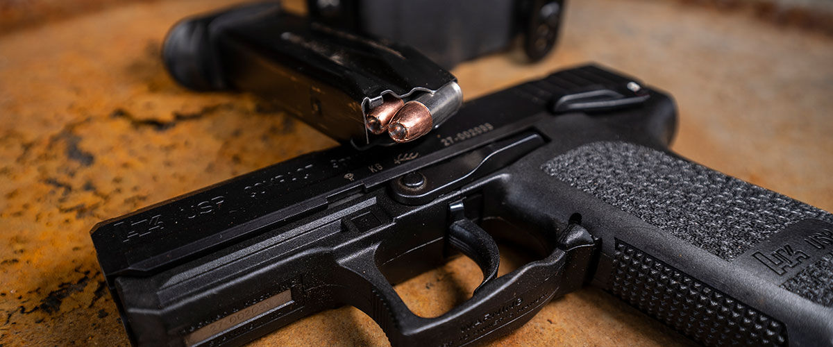 pistol with loaded magazine on a table
