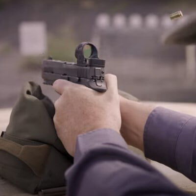 patrick kelley aiming a pistol resting on a bag