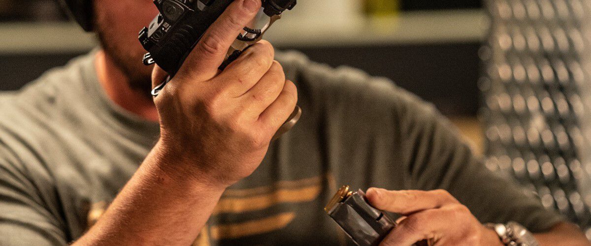 Person loading a pistol