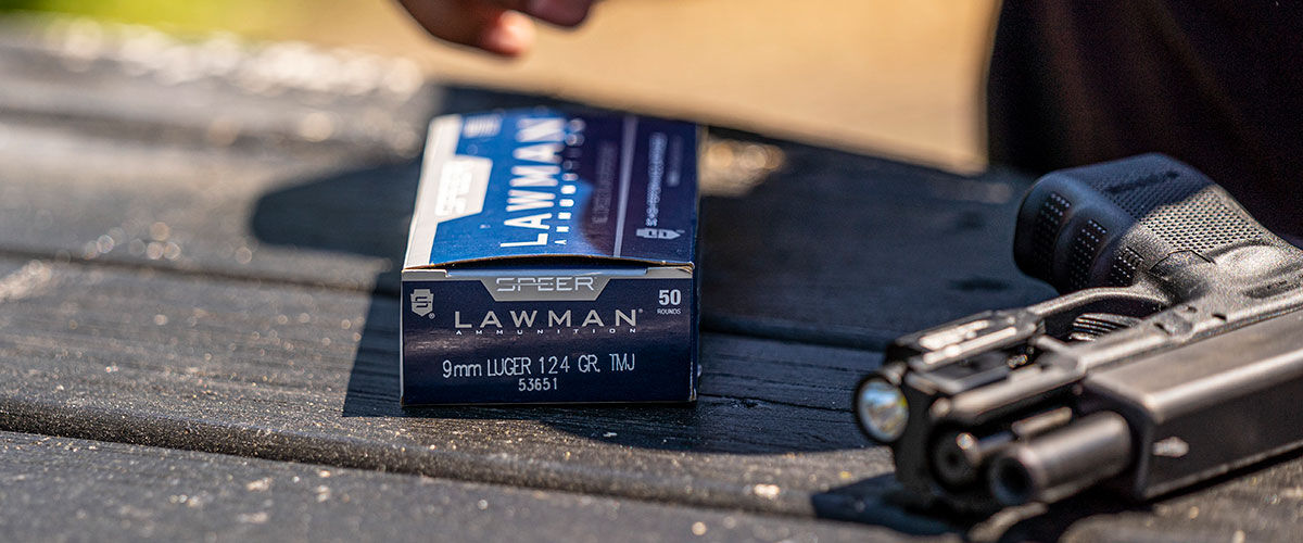 Lawman 9mm box and handgun on a table outside