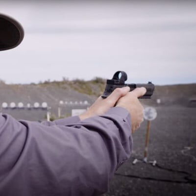 Patrick Kelley looking down the sights of a handgun