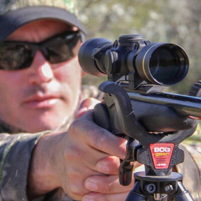 hunter looking down the scope of a handgun
