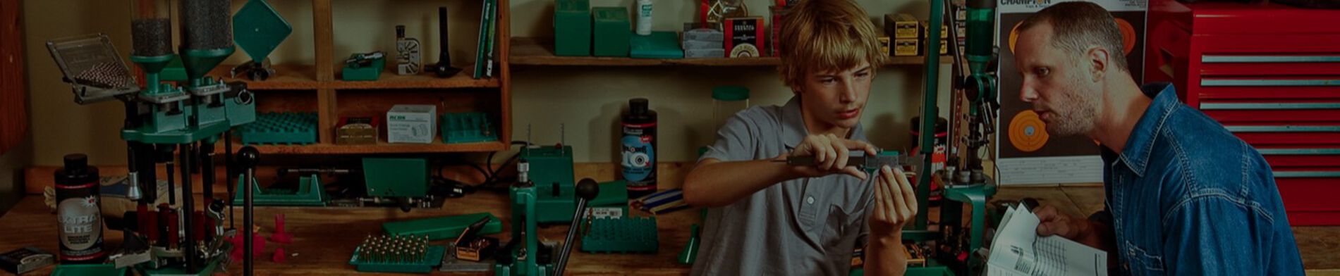 Father helping son learn about reloading