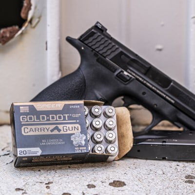 Gold Dot Carry Gun box sitting in front of a handgun