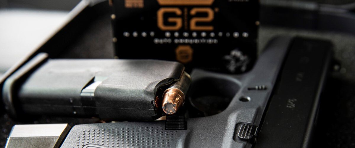 Gold Dot G2 cartridges in a magazine with the packaging in the background