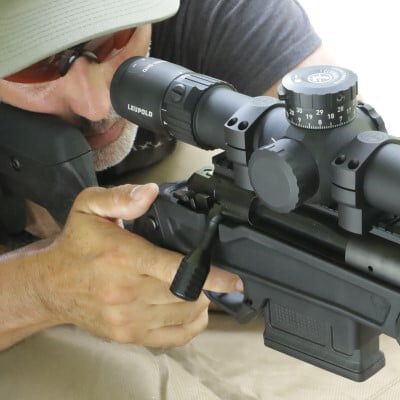 shooter looking down the scope of a rifle