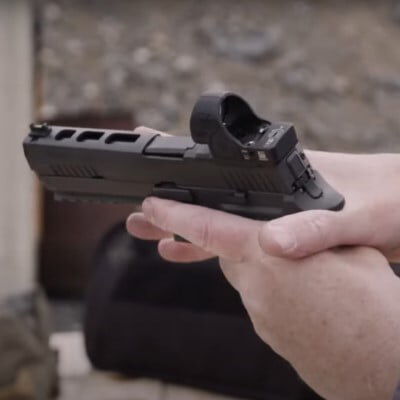 patrick kelley holding a handgun in both hands