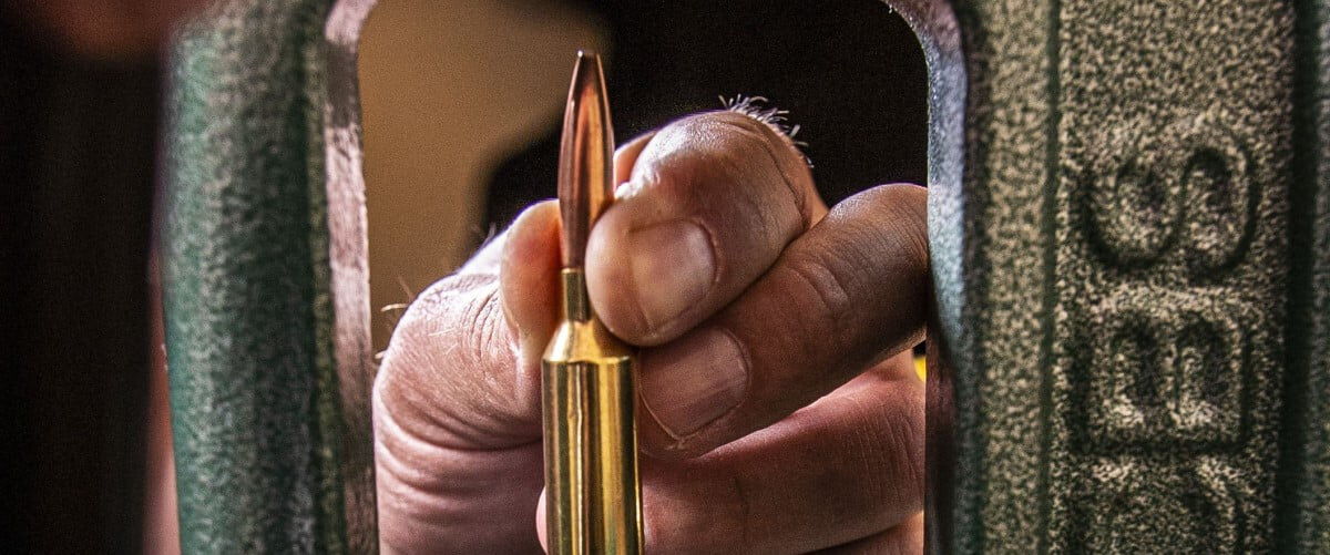 close up of a bullet being loading into a case using an RCBS reloader