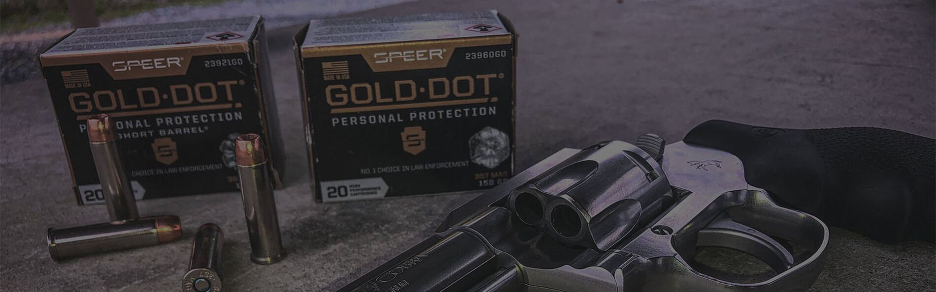 2 boxes of Gold Dot on the ground with a revolver