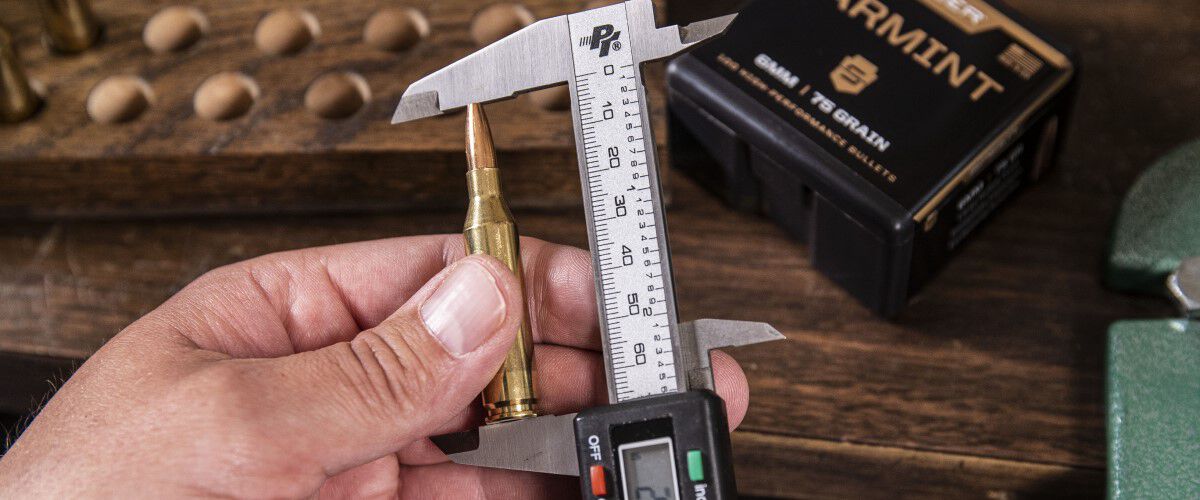a loaded bullet being measured