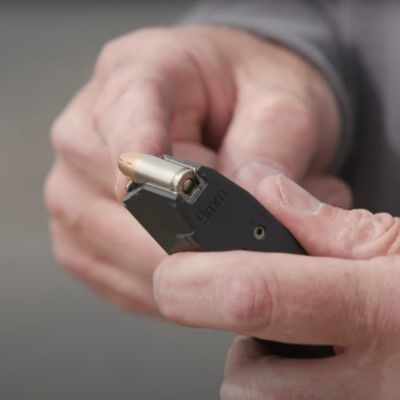 9mm Speer bullet being loaded into a magazine