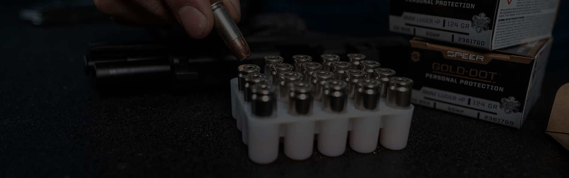 Gold Dot Personal Protection 9mm ammo being removed from container on a table