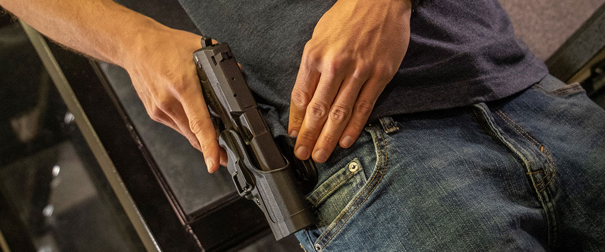 Person drawing a handgun from holster