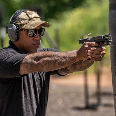 man pointing a pistol outside