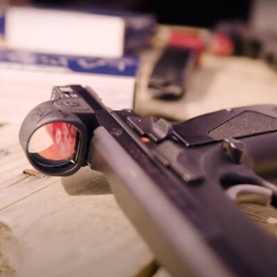 handgun with a red dot laying on a table