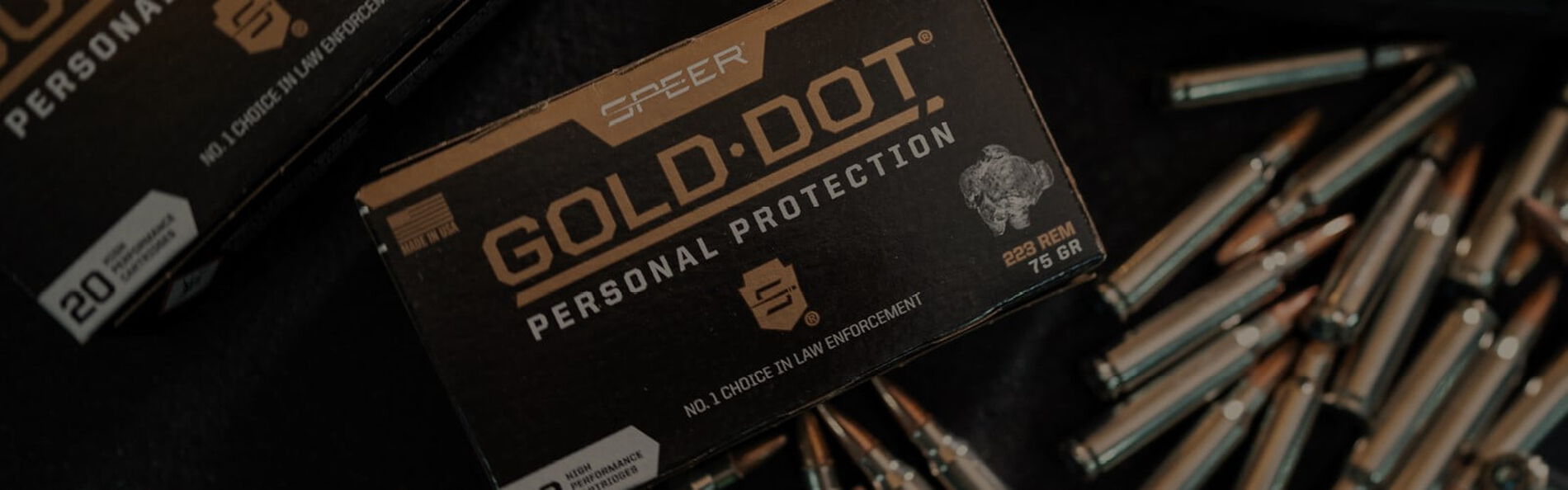 Gold Dot Rifle bos with cartridges laying on a table