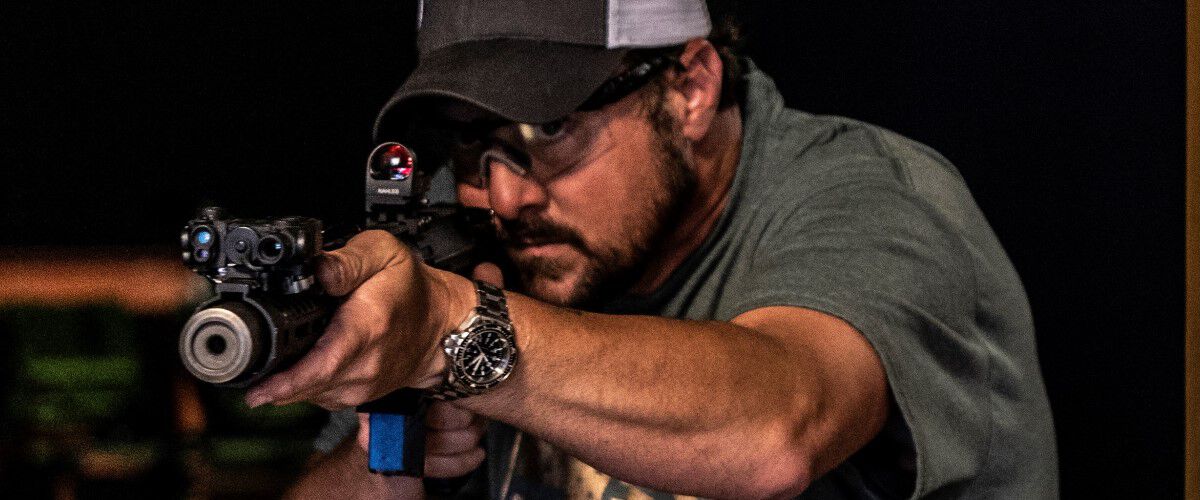 man pointing a rifle 