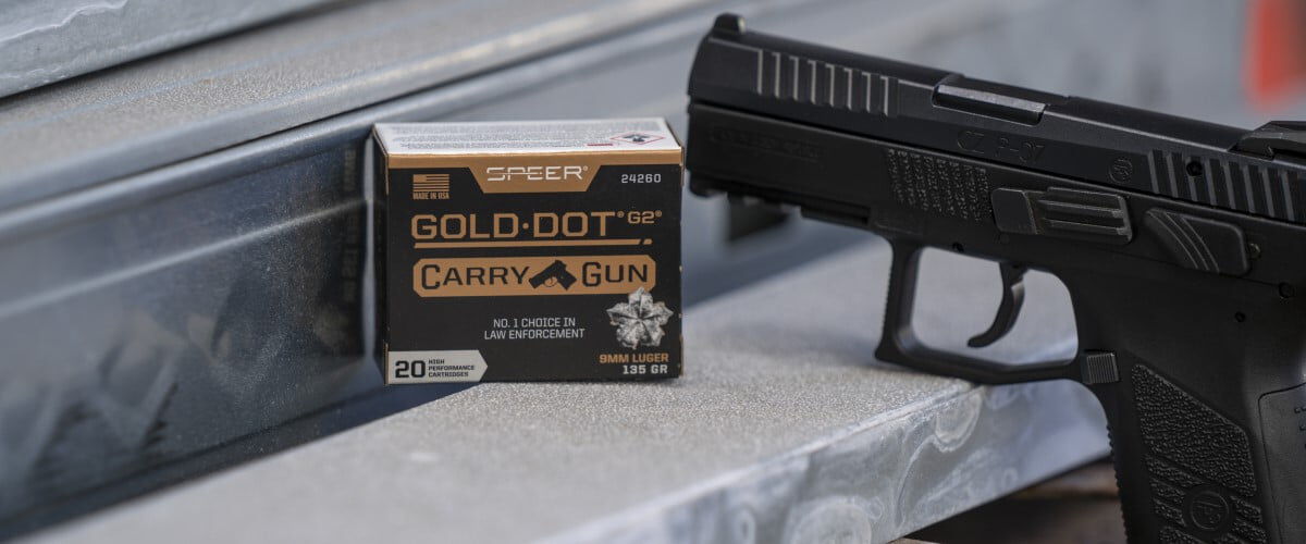 Gold Dot Carry Gun sitting next to a handgun